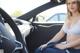 A woman sitting in the driver's seat of a car.