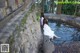 A couple of women sitting in a small pool of water.