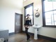 A woman standing in front of a sink in a room.