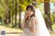 A woman in a wedding dress sitting on the ground.