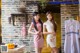 A couple of women standing next to each other in a kitchen.